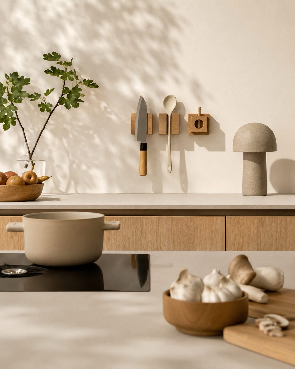 Minimalist oak kitchen wall storage holding a chef knife, wooden spoon and small organizer module above a warm wood kitchen counter.